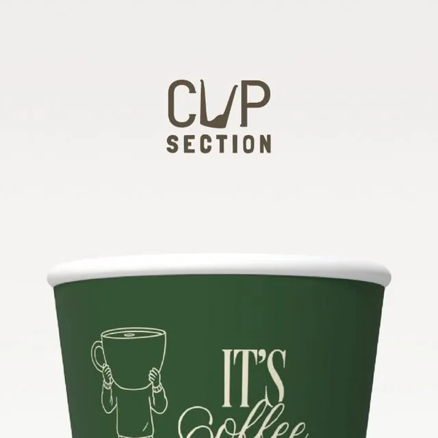 Forest green paper cup with a cream line drawing of a man lifting a giant coffee cup over his head, next to the words It's Coffee.
